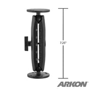 The 4-Hole AMPS Drill Base Mount features a black adjustable arm with round plates at both ends, a measurement line showing 7.25 inches in height, and a circular metal AMPS drill base for secure installation. The ARKON logo appears bottom right.