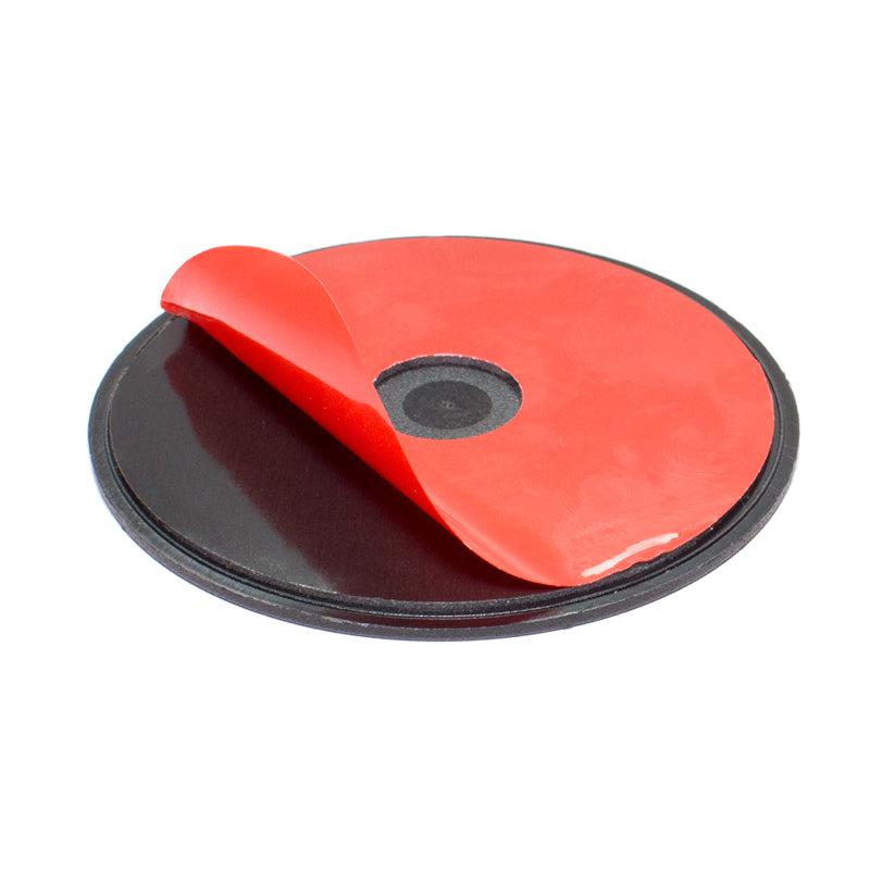 A round black 90mm VHB adhesive mounting disk with red peel-off backing reveals the sticky surface. Designed for car dashboards, it is ideal for mounting GPS units and smartphones using windshield suction pedestals.