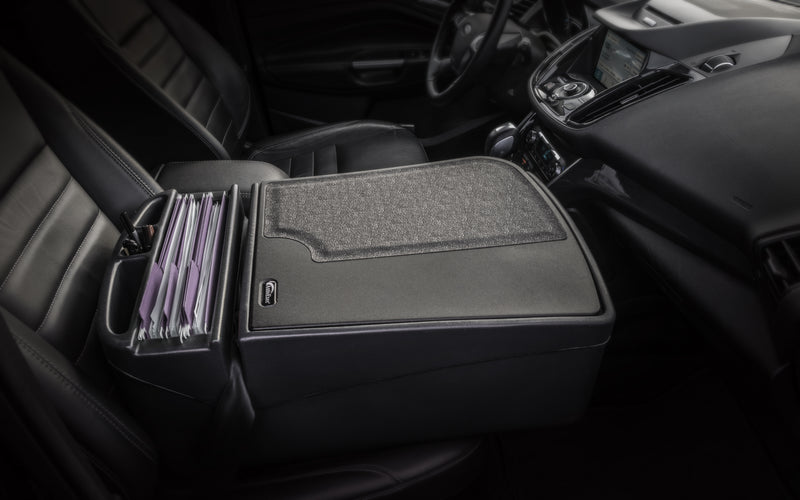 An Arkon Mounts AutoExec GripMaster Efficiency Car Desk positioned between the driver’s and passenger seat offers a spacious center console organizer that neatly holds multiple file folders, transforming your car interior into an organized mobile workstation or convenient desk on the go.