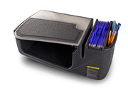The AutoExec GripMaster Efficiency Car Desk by Arkon Mounts features a black design with a textured lid, a compartment for files or folders, and side slots for pens and pencils—ideal as a passenger seat desk or mobile workstation. A yellow warning label is visible on the front.