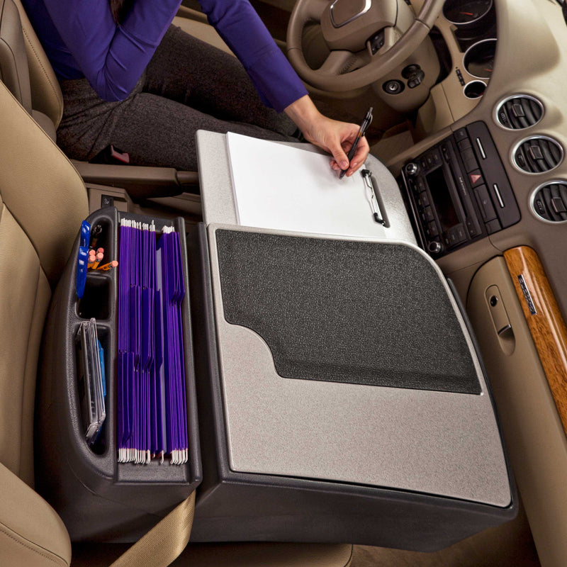 A person writes on a clipboard positioned on the Arkon Mounts AutoExec GripMaster Car Desk in the passenger seat, transforming it into a versatile mobile workstation featuring purple hanging file folders and built-in supply storage compartments.