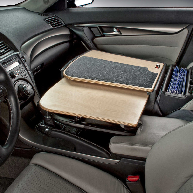 An Arkon Mounts AutoExec GripMaster Car Desk—a wooden workstation with a black mat—is installed over the passenger seat, providing a convenient mobile workspace. Office supplies are organized beside the seat console.