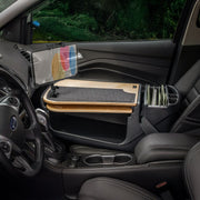 The AutoExec GripMaster Car Desk with LockVise™ Locking Tablet Holder and Multi-Angle Mount is installed over the front passenger seat, transforming the vehicle interior into a convenient mobile workstation.