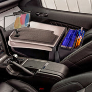 The AutoExec GripMaster Car Desk with LockVise™ Locking Tablet Holder and Multi-Angle Mount transforms your passenger seat into an organized workstation, providing a secure tablet holder, compartments for folders and pens, and a flat workspace above the glove compartment.
