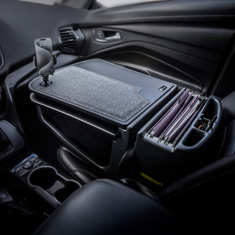 The AutoExec GripMaster Car Desk with Mega Grip™ Drill-Base Mount, featuring a felt surface and integrated file organizer, is installed in the passenger seat of a car to transform it into an organized mobile office for working on the go.