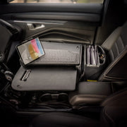 A car’s front passenger seat holds an Arkon Mounts AutoExec GripMaster Car Desk with Slim-Grip® Ultra Pro Drill-Base Mount, featuring a tablet mount, clipboard, and folder organizer to transform the space into a versatile mobile workstation.