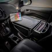 The AutoExec GripMaster Car Desk by Arkon Mounts transforms your car’s front seat into a modern, mobile workstation, featuring an organizer on the center console that secures file folders and a closed laptop, while the Slim-Grip® Ultra Pro Drill-Base Mount conveniently props up your tablet above.