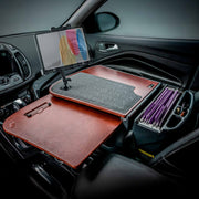 A mobile office setup inside a car featuring the AutoExec GripMaster Car Desk with LockVise™ Locking Tablet Holder and Multi-Angle Mount, complete with a clipboard, felt mat, and organized file folders neatly arranged on the passenger seat.