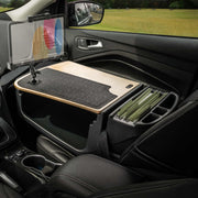 Here’s a rewritten version of your sentence using the provided product data: A car’s passenger seat workspace featuring the AutoExec GripMaster Efficiency Car Desk with a LockVise® Locking Tablet Holder and Multi-Angle Mount, along with an integrated file folder organizer. Parked in a grassy field visible through the window, this setup creates an ideal mobile workstation.