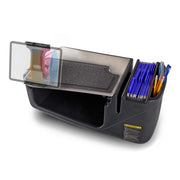 The GripMaster Efficiency Car Desk with Slim-Grip® Ultra Pro Drill-Base Mount by Arkon Mounts features a black organizer tray with a lid, effortlessly transforming into a convenient in-car desk. On the right, it accommodates blue file folders and pens, while its transparent left compartment displays keys, a wallet, and a cup inside.