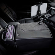 The AutoExec GripMaster Efficiency Car Desk with LockVise® Locking Tablet Holder and Multi-Angle Mount features a secure tablet holder on the center console, side compartments for organizing folders, and a textured work surface—all designed to create an efficient mobile workstation.