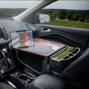 In the car interior, the front passenger seat is equipped with the Arkon Mounts GripMaster Efficiency Car Desk featuring a Slim-Grip® Ultra Pro Drill-Base Mount, neatly organizing folders and a pen holder while securely holding a tablet in place—transforming the seat into a functional mobile office.