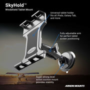 The SkyHold™ Windshield Tablet Mount, shown in black with an adjustable arm and suction base, is featured near a small airplane at sunset. Text highlights universal fit, secure suction, and an adjustable arm.