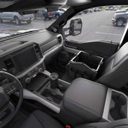 The interior of a parked pickup truck shows the front seats, dashboard, steering wheel, and a Portable Crate Workstation with Apron Organizer – Choose Your Mounting Setup placed on the passenger seat, offering convenient storage and versatile device mounting options for those using the vehicle as a mobile workstation.