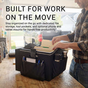 A person organizes folders and tools in the Portable Crate Workstation with Apron Organizer – Choose Your Mounting Setup, displayed on a table in a garage. The efficient mobile workstation highlights flexible device mounting options and features text promoting enhanced productivity for work on the go.
