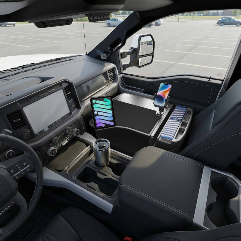 Inside the truck, an AutoExec GripMaster Efficiency Car Desk is installed, featuring the Mega Grip™ and Slim-Grip® Ultra Pro Drill-Base Mounts that securely hold a tablet and smartphone. A stainless steel travel mug sits in the cupholder while the vehicle is parked in an empty parking lot.