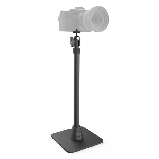 A Desk Stand with 29 Height Adjustable Arm for MEVO, Cameras features a black, square base holder supporting a MEVO live streaming camera. The focus is on the stand while the camera appears faded and semi-transparent.