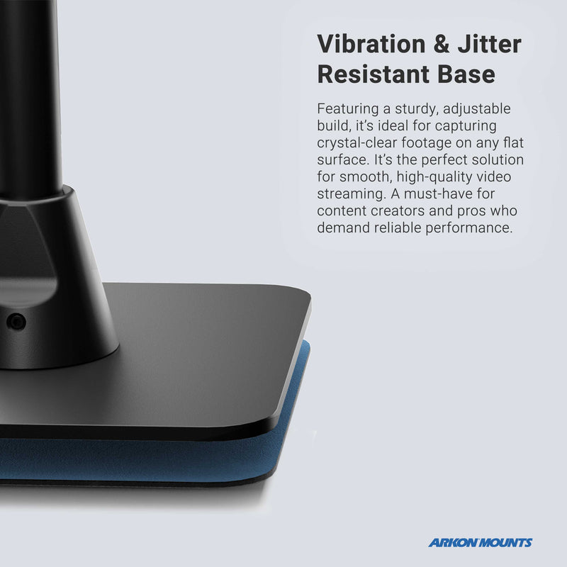 Close-up of the Desk Stand with 29 Height Adjustable Arm for MEVO, Cameras featuring a sturdy flat base on a blue pad. Text highlights its vibration and jitter resistance. Arkon Mounts logo appears at the bottom right.