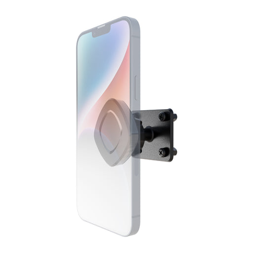 A transparent smartphone is attached to the Arkon Mounts Magnetic Holder with Adhesive Drill Base Mount, which has a black square base secured by four screws and features a 4-hole AMPS adapter, viewed from an angle.