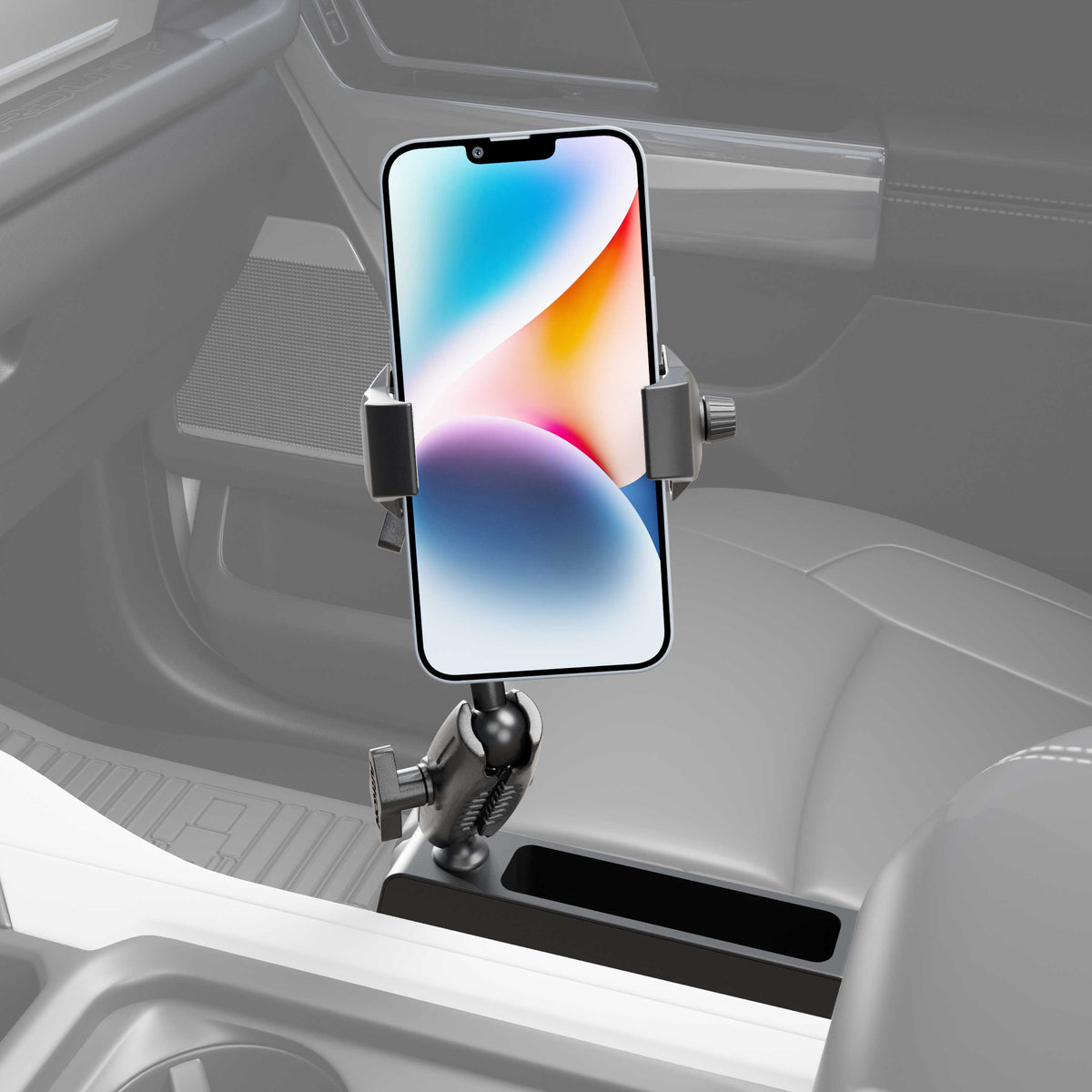 A Car Seat Wedge RoadVise® Ultra Phone Holder with Dual Shaft Arms holds a smartphone upright in a car’s cup holder. The vehicle’s seats and dashboard are visible in the background.
