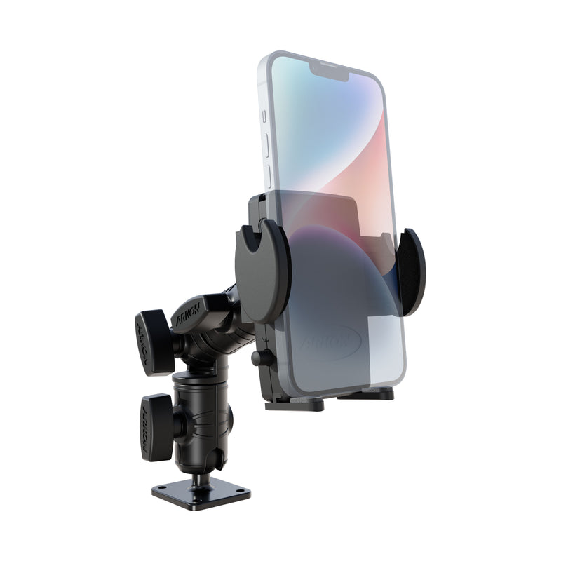 A Mega Grip™ Phone Drill-Base Mount with Ratchet Arm, shown in black and holding a smartphone securely in its adjustable grips, is attached to a flat base that features an AMPS 4-hole pattern and multiple swivel joints for versatile, flexible positioning.