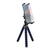An iPhone is mounted on a Slim-Grip® Ultra Tripod Mount with black and blue striped flexible legs, standing upright against a white background.