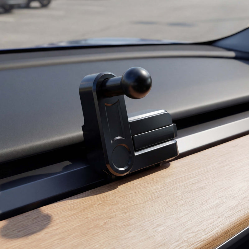 A close-up of the Vent Mount for Tesla Model 3 (2017-2022) and Model Y (2020-2023), featuring a black ball-shaped handle, is shown custom-fitted on a car dashboard beside sleek wooden trim, with the windshield framing an outdoor backdrop—making it the perfect accessory for your Tesla Model 3 or Model Y.