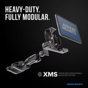 A modular mounting system, the XMS™ Heavy Duty Forklift Mount with LockVise™ Metal XL Locking Tablet Holder, is ideal for warehouse tablet mounting and holds a tablet labeled Arkon Mounts. Bold text reads, Heavy-Duty. Fully Modular. XMS™ and Arkon Mounts branding are visible on a black background.