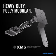 A rugged, fully modular mounting solution with adjustable components for versatile warehouse device installation, shown on a black background. Text reads: HEAVY-DUTY. FULLY MODULAR. XMS™ Heavy Duty Forklift Mount with Dual Utility Mounting Bracket—VESA and AMPS compatible for flexible configuration options. Arkon Mounts logo at the bottom.