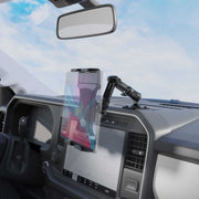 A tablet held in a Slim-Grip® Ultra Pro Tablet Mount with 8″ Adjustable Arm & AMPS Drill Base secured to the dashboard of a vehicle.