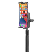 A smartphone mounted vertically in a black Slim-Grip® Ultra Phone Holder with Seat Rail Mount and 18-Inch Bendable Gooseneck displays a colorful home screen with various app icons—an ideal commercial vehicle phone mount solution for secure, adjustable use.