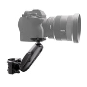 An XMS™ U-Bolt Mount with Camera Pedestal, finished in black and built for heavy-duty use, is attached to the bottom of a camera with a large lens. The mount includes adjustable joints for flexible angling and positioning. Both the camera and lens are shown as partially transparent.