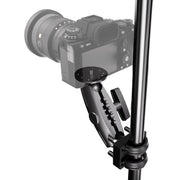A camera is mounted to a vertical metal pole using the XMS™ U-Bolt Mount with Camera Pedestal, which features an adjustable clamp arm, a round mounting plate, and tightening knobs.