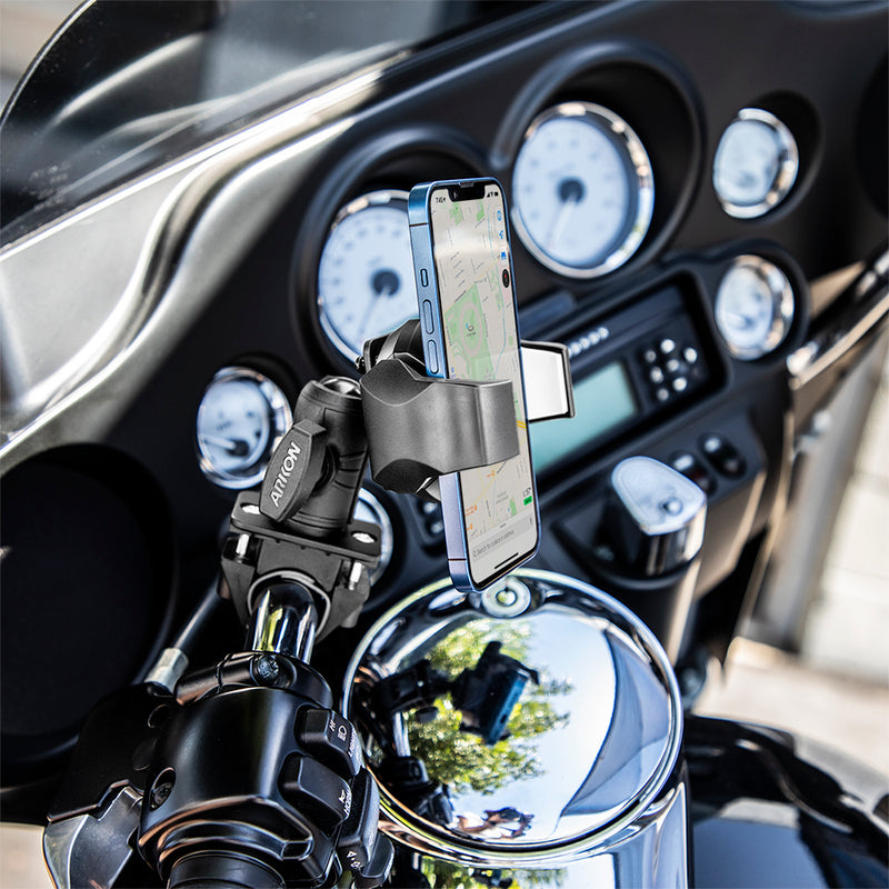 A smartphone is mounted on a motorcycle handlebar using the OCTO™ Rail Mount with RoadVise® Ultra Phone Holder, displaying a navigation map. The motorcycle dashboard with several gauges is visible in the background, highlighting the secure setup provided by the OCTO™ Rail Mount and RoadVise® Ultra Phone Holder.