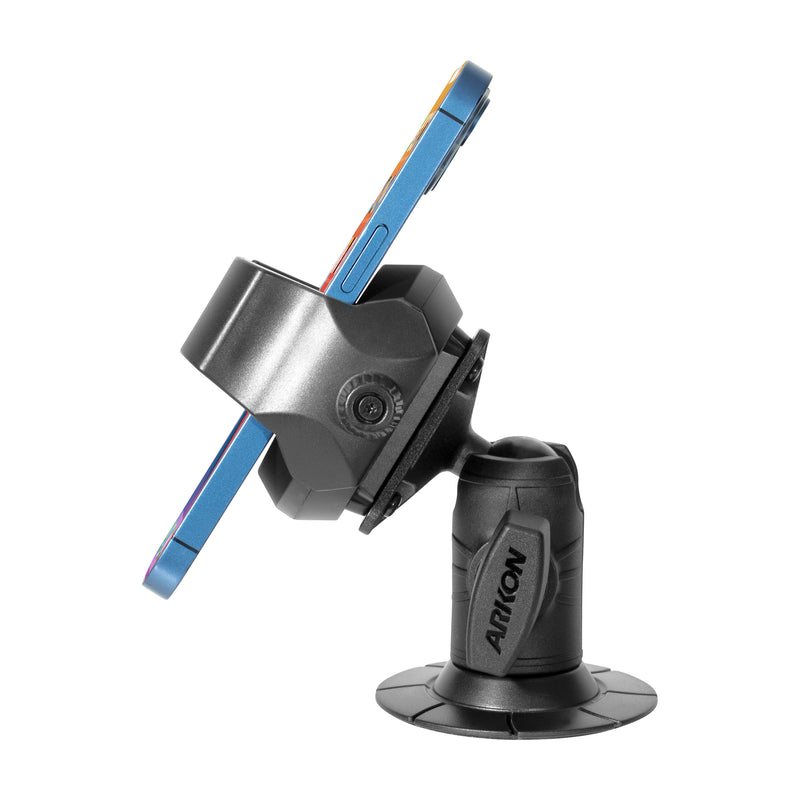 A smartphone mounted horizontally in a black RoadVise® Ultra Phone and Tablet Holder with an adhesive base and 2” shaft arm, shown in side profile on a white background. The holder is MagSafe charger compatible for convenience.