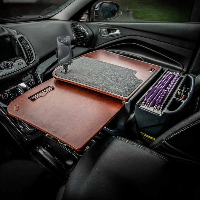 With the AutoExec GripMaster Car Desk featuring a Mega Grip™ Drill-Base Mount, your car’s front seat transforms into a mobile office workstation—complete with a sturdy wooden desk, a clipboard, and an organizer for file folders conveniently situated beside the passenger seat.