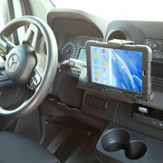 A Mercedes-Benz dashboard features a rugged-cased tablet, held securely beside the steering wheel by the LockVise™ Metal Locking Tablet Mount with Drill Base Mount, displaying a colorful home screen with app icons.