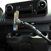 A smartphone is secured in the RoadVise® XL Heavy-Duty Seat Rail or Floor Tablet or Phone Mount, installed near the dashboard above the cup holders and controls, keeping apps visible for safe, easy access while driving.