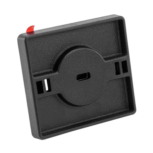 The Adhesive Security Plate with Slot is a square, black plastic plate featuring a central slot, two holes per side, and a small red top tab; it secures laptops, tablets, or monitors with cables and supports Kensington-style lock systems.