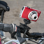 A Canon Sony Samsung Panasonic Nikon camera, mounted on handlebars with the Bike or Motorcycle Handlebar Camera Mount (1/4-20 pattern), sits next to the brake lever and grip.
