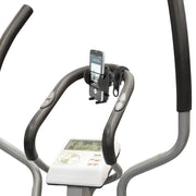 Close-up of an elliptical’s handlebars, control panel, and the Bike or Motorcycle Mega Grip™ Phone Holder Strap Mount for iPhone, Galaxy, and Note with a phone attached. The display shows workout data like time, distance, and calories burned.