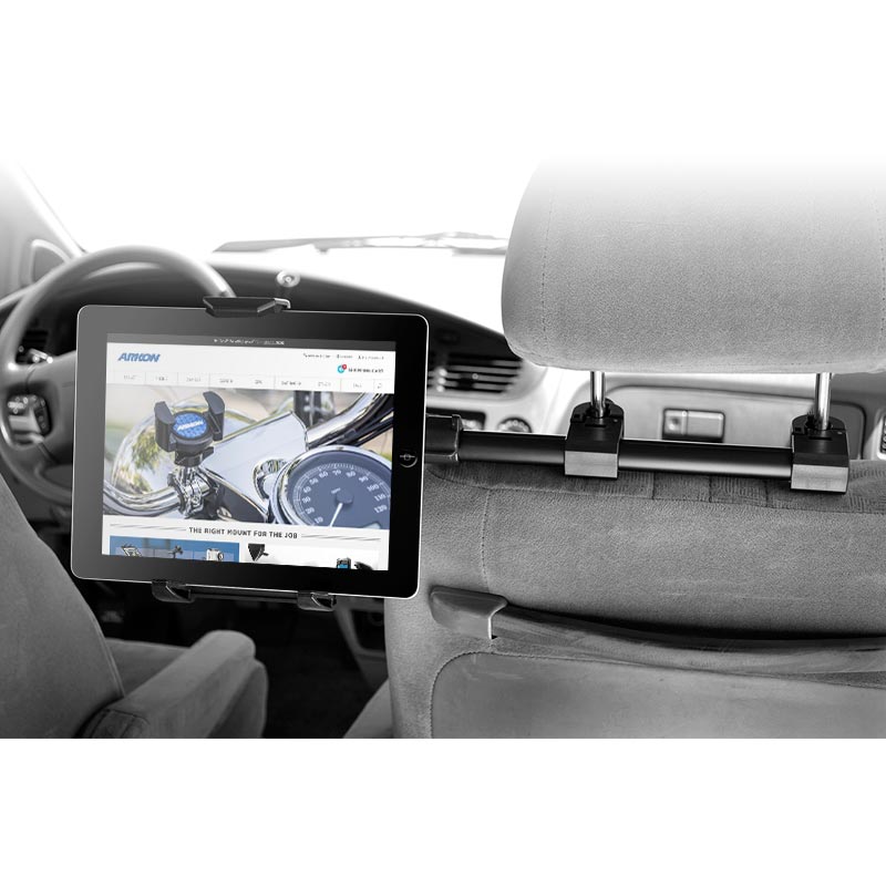 A Car Headrest Extension Tablet Mount for iPad, Note, and more holds a tablet on the car’s front seat headrest, displaying a website with the interior and dashboard in view—ideal for rear seat entertainment.