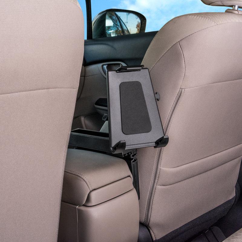 The Car Seat Console Wedge Tablet Mount is attached behind a beige car seat, with the rear passenger door and window seen in the background, and is conveniently positioned for easy access by backseat passengers.