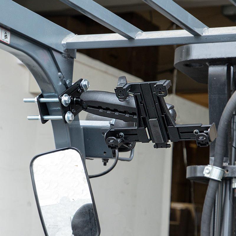 The LockVise™ Locking Forklift Front Guard Tablet Mount with 10.25 inch Metal Robust™ Shaft attaches securely to a forklift’s metal frame near the driver’s seat mirror, providing easy access and visibility for convenient warehouse use.
