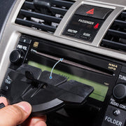 A hand removes the plastic cover from the car stereo slot, revealing a 17mm ball adapter for installing the GPS CD Slot Mount Holder for Garmin GPS.