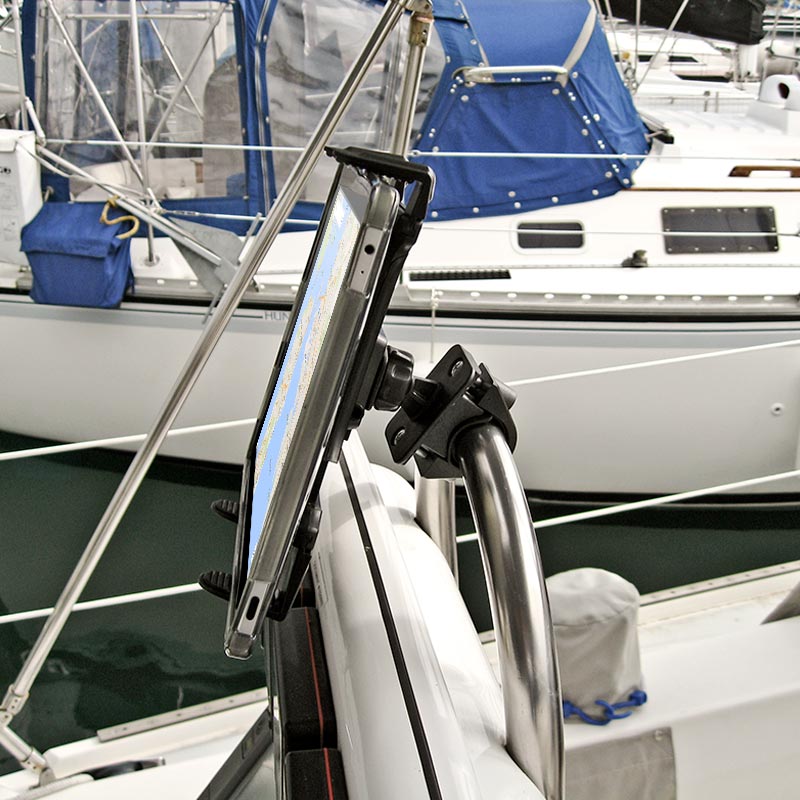 The Handlebar Slim-Grip® Tablet Mount secures an iPad or Note to a boats metal rail, displaying a nautical chart with other boats and blue canvas covers visible in the background.