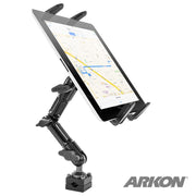 The Heavy-Duty Slim-Grip® Tablet Headrest Mount with Multi-Angle 8 Arm securely holds a tablet showing a map. This black adjustable rear seat mount for iPad and Note is pictured on a white background with the Arkon logo in the bottom right corner.