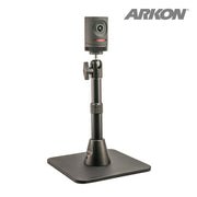 A compact black Mevo camera sits on the Height-Adjustable Camera Desk Stand (7.5 to 9.75 inches tall), shown with a square base on a white background. ARKON branding appears in the top right corner, ideal for live streaming setups.