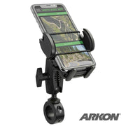 A smartphone on the Mega Grip 25mm Robust Aluminum Motorcycle Handlebar Smartphone Mount displays a navigation map. The black holder, with ARKON logo at bottom right, fits both motorcycles and bicycles.