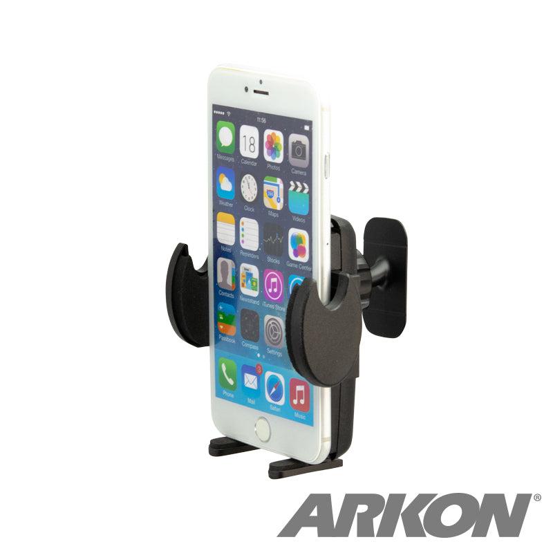 An iPhone sits in the Mega Grip™ Car Phone Holder with Adhesive Mount for iPhone, Galaxy, and Note. The black adjustable mount makes hands-free calls safe and convenient, displaying app icons and time while driving. The ARKON logo is visible.